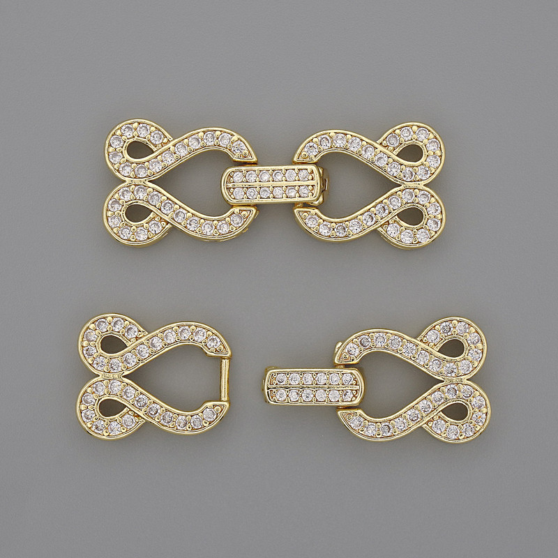 Two-thread clasp with white crystals, diameter 30x12 mm, gold-tone metal