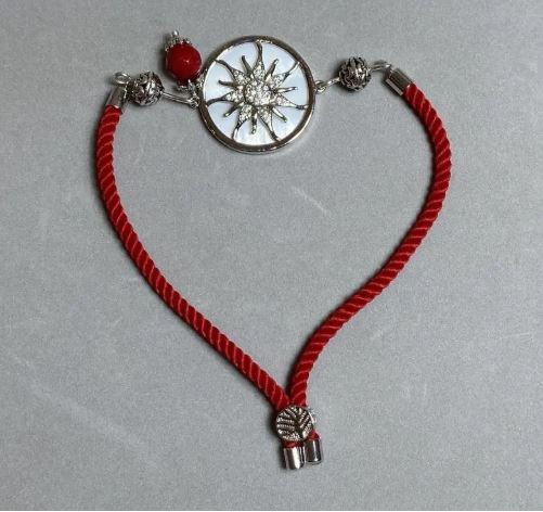 Textile bracelet, 5.5 mm diameter +/-, adjustable, with a silver-colored metal insert, 24 mm diameter +/-