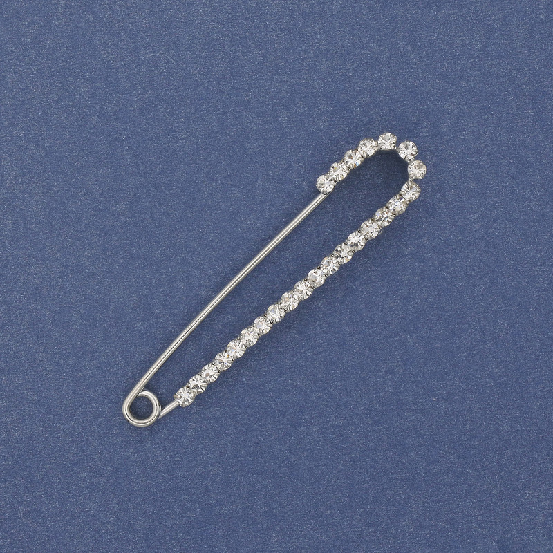Brooch pin with white rhinestones 56×11 mm ± silver-colored metal