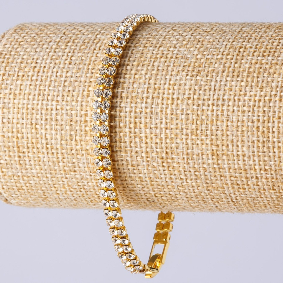 Two-row rhinestone bracelet on a clasp, metal color "gold", length 19 cm, width 5 mm