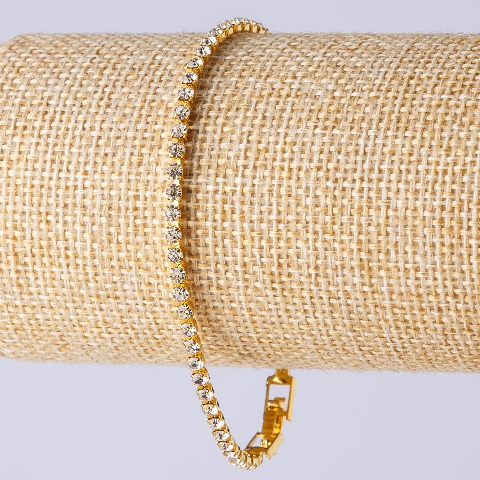 Rhinestone bracelet with a clasp, single-row, metal color "gold", length 20 cm, width 3 mm