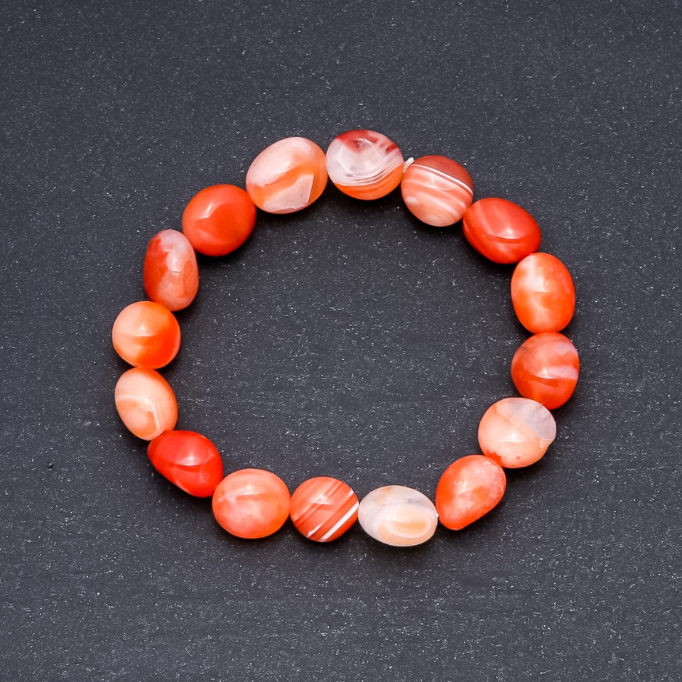 Orange faceted agate bracelet, 10x12 mm diameter on elastic