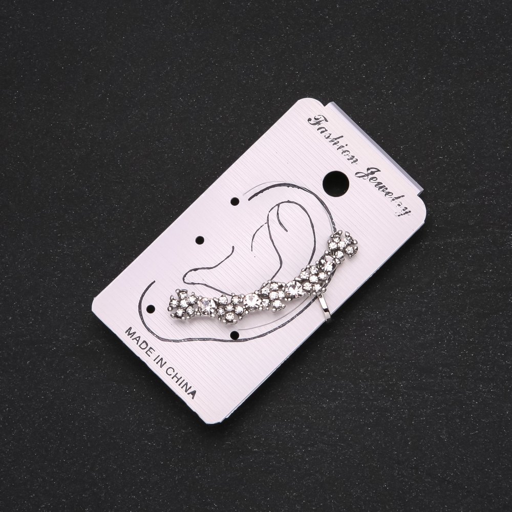 Silver ear cuff with white crystals and white flowers