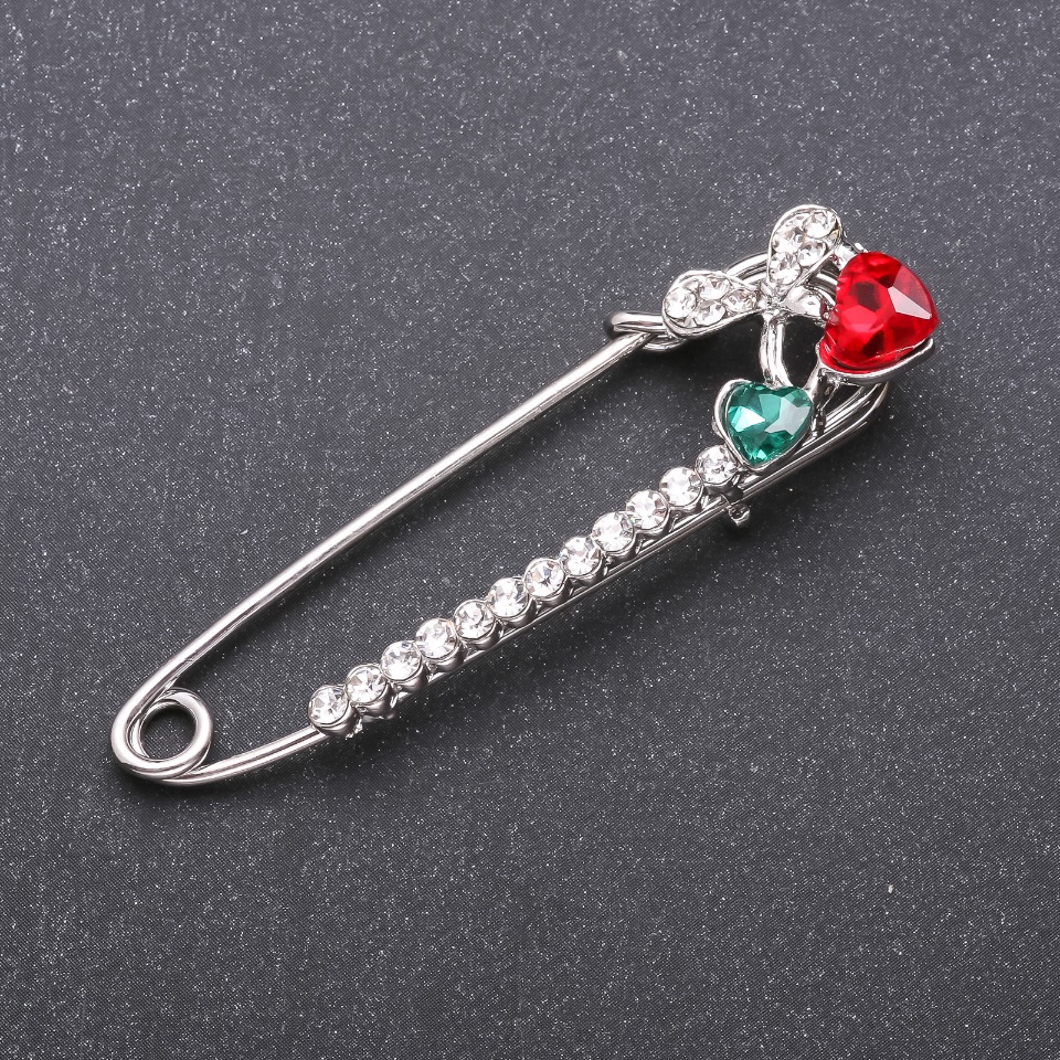 Brooch pin with red and green glass crystals, 64×18 mm, white metal
