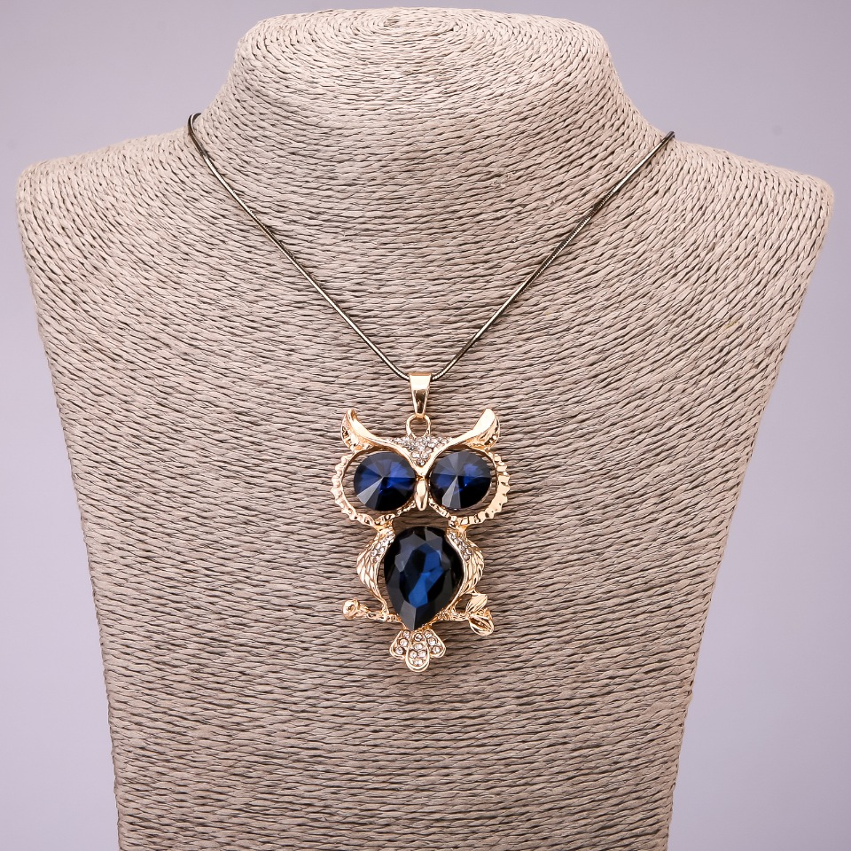 Pendant 'Owl' with blue crystals on a long chain of black-gold metal, diameter 41×62 mm, length 70 cm