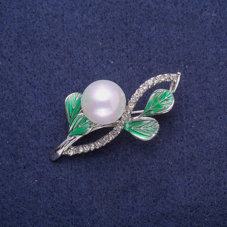 Brooch 'Twig' with enamel, rhinestones and pearl, silver-toned metal 27x48mm