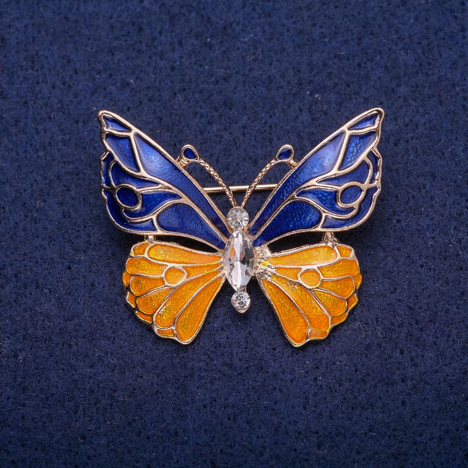 Butterfly Brooch with blue and yellow enamel, white crystal, gold-tone metal 30x36mm