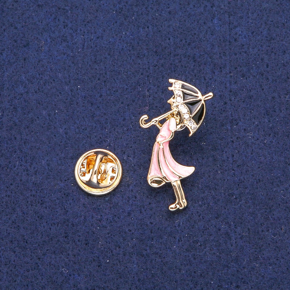 Brooch 'Lady with an Umbrella', white crystals, pink and black enamel, golden metal 18x32 mm
