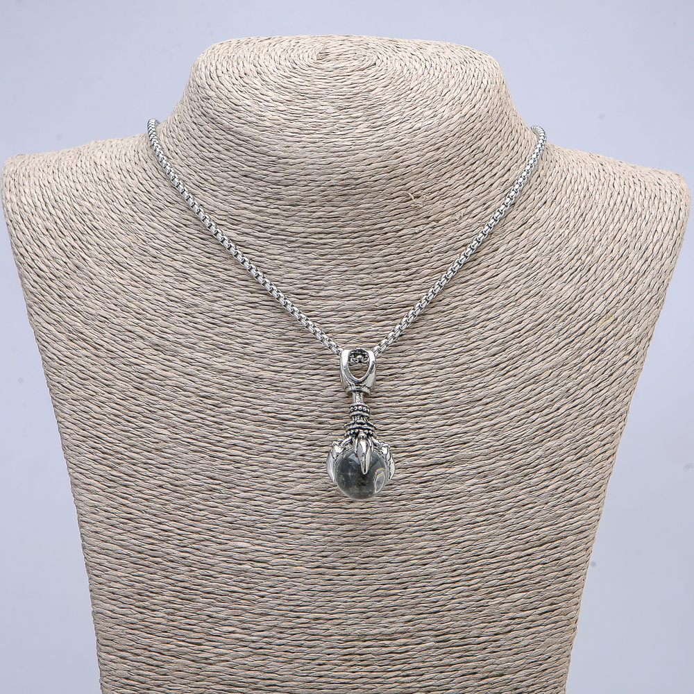 Pendant 'Paw with Sphere' 45x20 mm on a chain, length about 70 cm, silver-toned metal