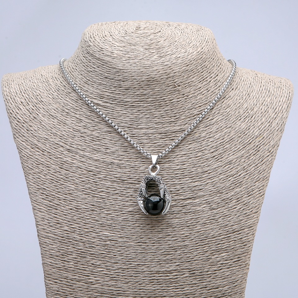 Pendant "Ball in a Paw" black 42 x 22 mm on a chain, length 70 cm +/- silver-toned metal