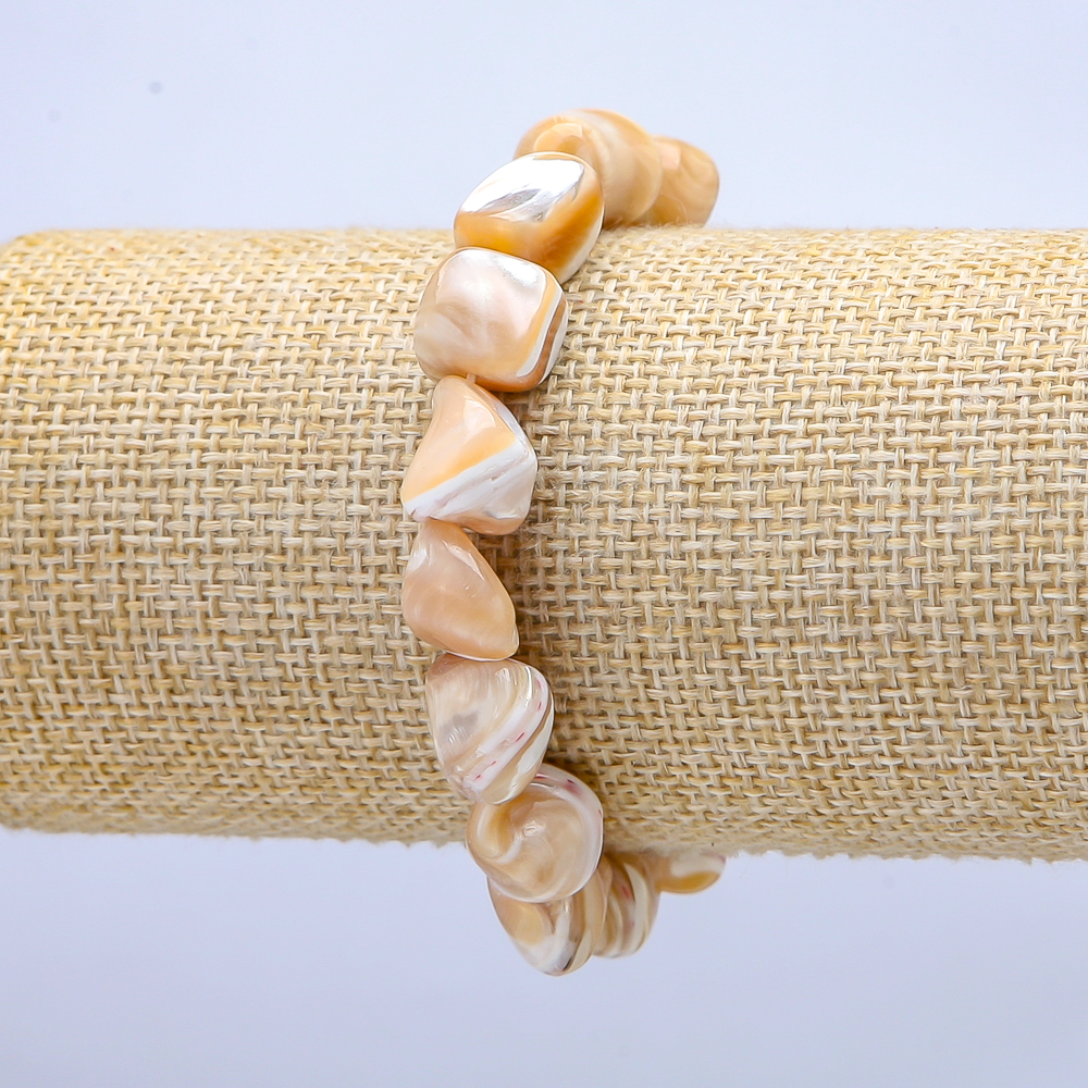 Elastic bracelet natural beige. Faceted mother-of-pearl, diameter 19×12 mm, length 18 cm+