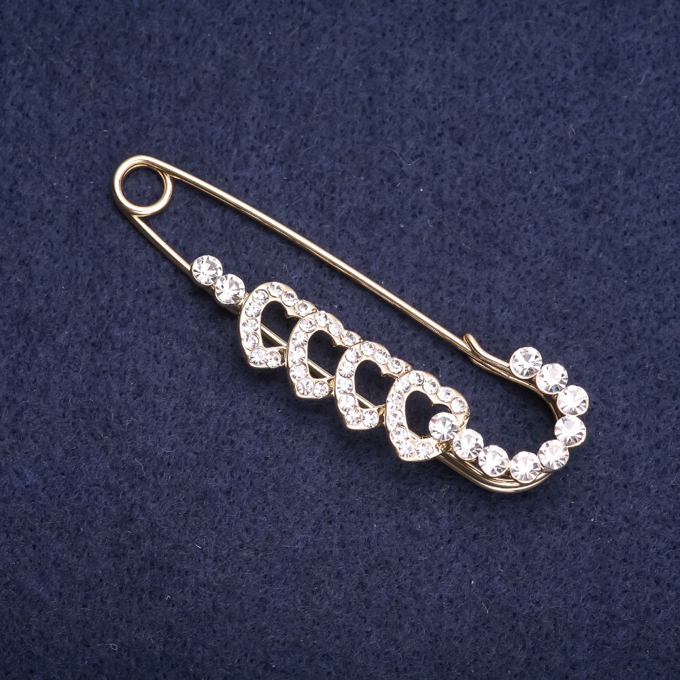 Heart-shaped brooch pin with white rhinestones, 65x20 mm, yellow metal