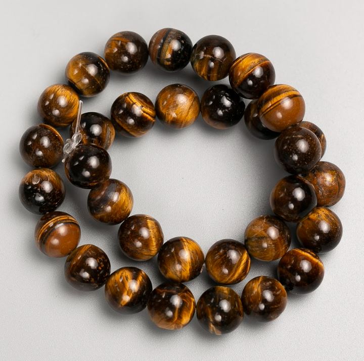Beads on a fishing line of natural Tiger's Eye stone, diameter 12 mm, length 38 cm