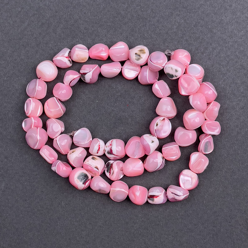 Faceted beads, pink-tinted mother-of-pearl, 8x6 mm, approx. 41 cm on thread