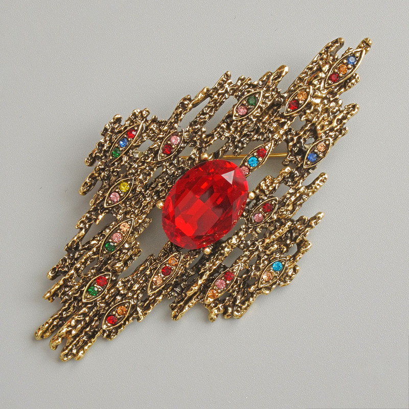 Accent brooch-pendant with red crystal, multicolored rhinestones, dark-gold metal 44x81 mm